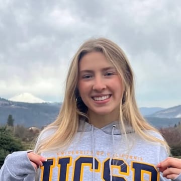 Magnolia Clermont holding up a UC Santa Barbara sweatshirt